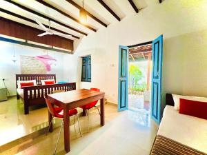 a living room with a table and a couch at Krishan Villa in Negombo