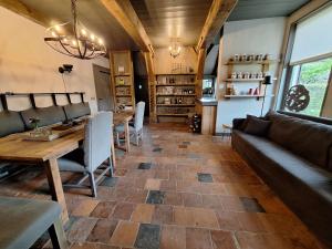 a living room with a couch and a table at B&B De Meidoornhof in Ruinen
