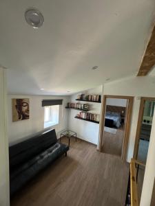 a living room with a black couch and a window at Casa La Molina in Burgos