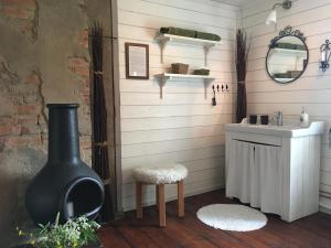 a bathroom with a sink and a toilet and a mirror at Lavendeltorpet in Häggum +91 photos
