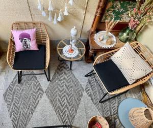 een kamer met stoelen en een kussen met een hond bij Maison face au moulin Giverny in Vernon