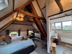 a bedroom with a large bed and a bathroom at B&B De Meidoornhof in Ruinen