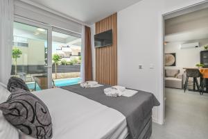 a bedroom with a bed and a living room at Smash A - Apartments with Private Pool in Novalja