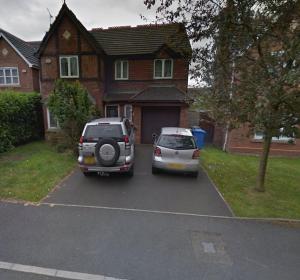 two cars parked in a parking lot in front of a house at Big new house! 5BDR, sleeps 13, with parking in Carrington