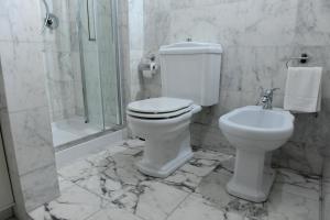 a bathroom with a toilet and a shower and a sink at ARIA DI CASA APARTMENT in Florence