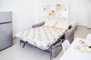 a bed in a room with a refrigerator at Urban loft in Forio d'Ischia