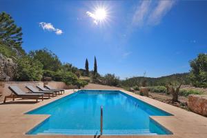 a swimming pool with lounge chairs and a blue sky at Chambre d'hôtes Les Temps Heureux in Callian