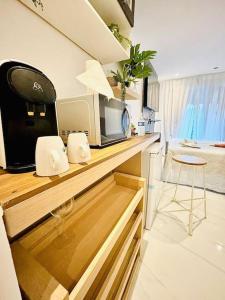 a kitchen with a counter with a microwave and a chair at Studio Love Jacuzzi in Marseille