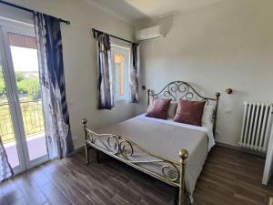 a bedroom with a metal bed with pillows on it at Robert's Sweet Station House A in Anguillara Sabazia