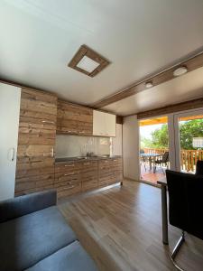 a living room with a couch and a kitchen at MIMOSA Luxury Mobile Homes in Sveti Juraj +10 photos
