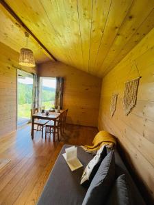 a living room with a couch and a table at Pod dobrym adresem- domek pod lasem in Cisna