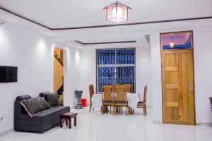 a living room with a table and chairs at Heim Villa in Moshi