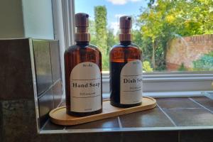 two bottles of wine sitting on a counter next to a window at Windsor property near Legoland with free parking in Windsor