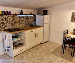 a kitchen with a white refrigerator and a table at Casa Naturista Con Vistas in Oria