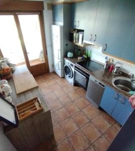 a kitchen with a sink and a stove top oven at Appartement - Hendaye in Hendaye