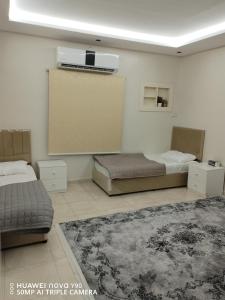 Ένα ή περισσότερα κρεβάτια σε δωμάτιο στο نزل تمارا 1