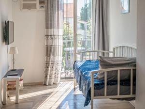 a bedroom with a bed and a large window at Apartmani Maria - Studio 2 in Vantačići
