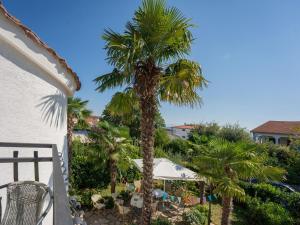 a view of a palm tree from a balcony at Apartmani Maria - Studio 2 in Vantačići