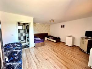 an empty room with a bed and a television at Pensiunea Bianca in Corbu