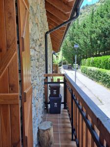 a porch of a house with a wooden door at Dúplex de muntanya en zona verda a Escaló in Escaló