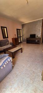 a large living room with a couch and a television at Beach house Cala Morlanda in S'Illot