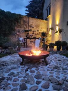 a fire pit sitting on a stone patio at Ferienhaus Alte Schmiede - weites Land in Lutherstadt Wittenberg