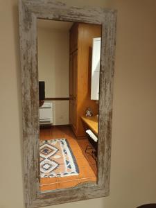 a mirror reflecting a room with a table at LES ALZINES piscina Privada! B&B No cocina in Costa del Maresme
