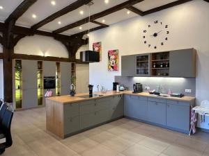 a large kitchen with a clock on the wall at Ferienwohnung Ottenhof in Verden