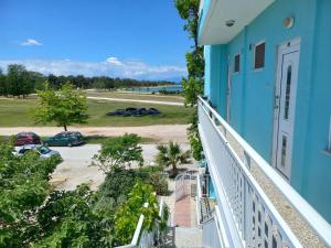 a balcony of a blue building with a parking lot at Karagiannis in Keramoti