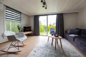 una sala de estar con un sofá y una mesa en 37, located in a quiet & wooded area!, en Oisterwijk