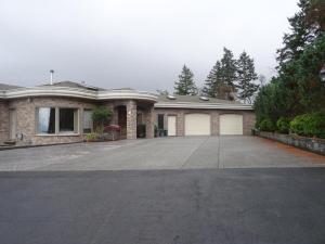 a house with a large driveway in front of it at Gibralter Rock Ocean View B&B in Nanaimo +22 photos