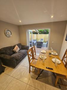 a living room with a wooden table and a couch at 7 Eyre Square Lane in Galway