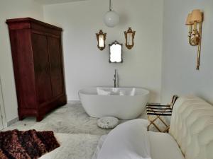 a bathroom with a bath tub and a sink at Andrews Luxury Apartment in La Spezia