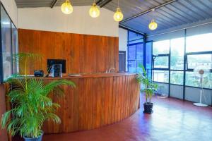 an office with a reception desk and potted plants at Vendol Lake Resort - Kandy in Kandy