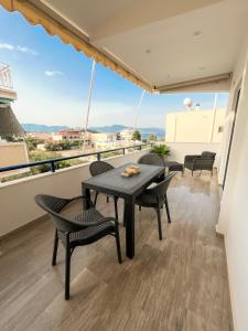 a balcony with a table and chairs and a view at Room 4 in Loutra Oraias Elenis 