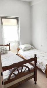 two beds in a room with a window at Hostel Flash in Ulcinj