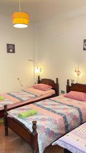 two twin beds in a room with at Hostel Flash in Ulcinj