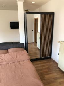a bedroom with a bed and a large mirror at Apartment #1 in Olsbrücken