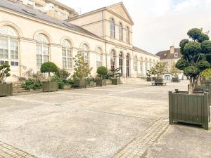 a large building with trees in front of it at Studio coeur de ville paisible in Alençon