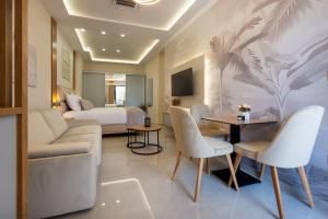 a hotel room with a bed and a couch and chairs at Apartmani Laguna in Neum