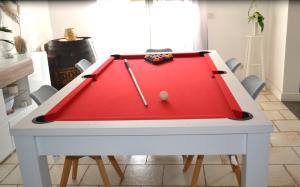 a ping pong table with a red cloth at Spassionnement pool in Jouy-le-Moutier