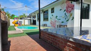 a house with a mural on the side of it at LeCamar STAYCATION Swimming Pool and Fully Air-conditioned at Bukit Katil 4 Queen-sized Bed and 3 Single-sized Bed in Malacca