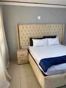 Postel nebo postele na pokoji v ubytování Machogeguestlodge