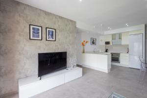 a large living room with a large tv on a wall at Residencia de Lujo Frente al Mar in Playa de Gandia