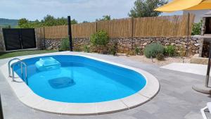 a swimming pool in a yard with a fence at M&S Paradise Bilice, Šibenik in Vrulje