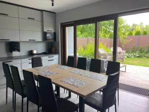 a kitchen and dining room with a table and chairs at Arcadia Home in Będzin