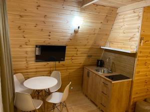 a small kitchen with a table and a sink at Kvirike Gardens in Kobuleti