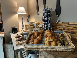 a tray of pastries and other baked goods on a table at Hotel Best Western La Mare Ô Poissons in Ouistreham