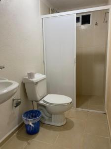 a bathroom with a toilet and a sink and a shower at Cabañas Dobles Barra la Saladita in La Salada