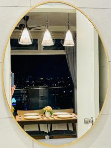 a person taking a picture of a table in a mirror at Kuching City Center Riverine Apartment With Balcony and Marvelous View in Kuching
